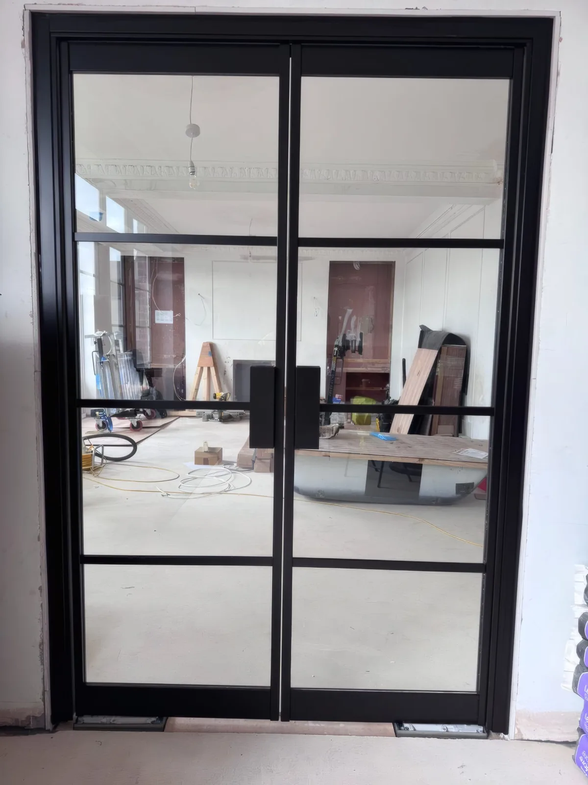 Completed glazed partition door to a period office space, black-framed to match the building’s character.
