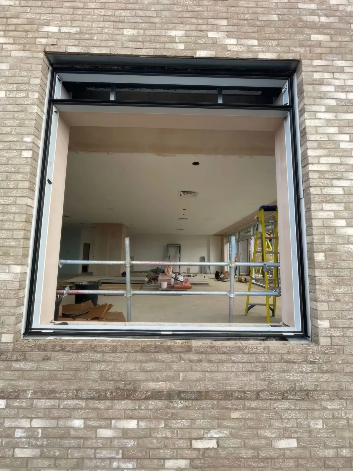 A window opening in the brick facade, prepared and ready to receive its glazing unit.