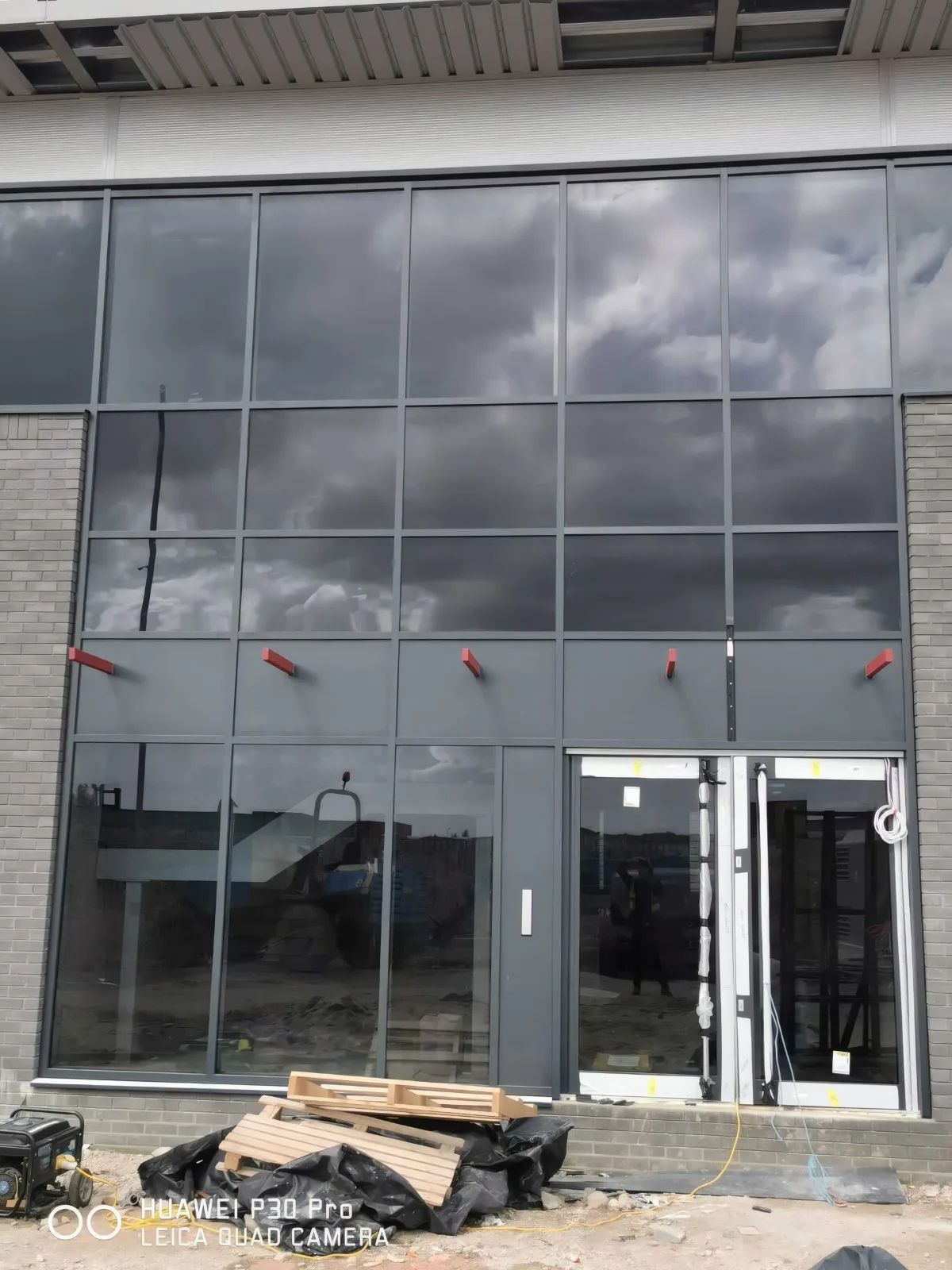 The glazed entrance screen and double doors, ahead of final finishes.