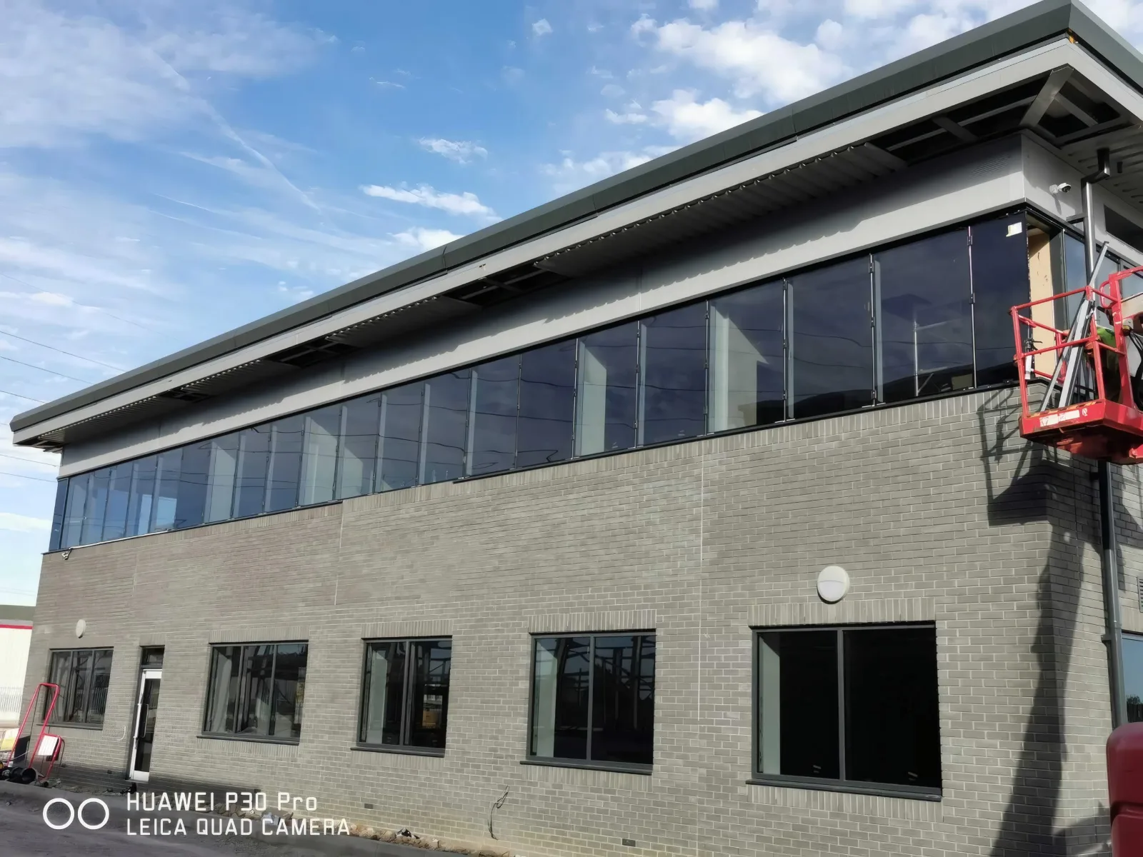 An office block with a continuous band of glazing beneath the roof.