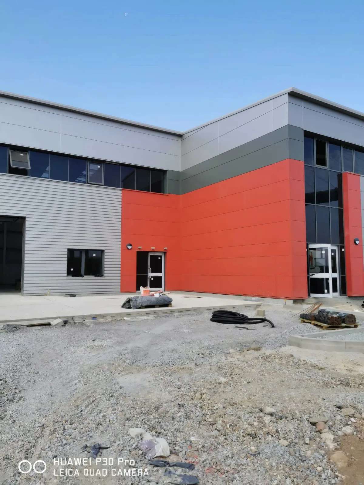 A unit entrance with red feature cladding.