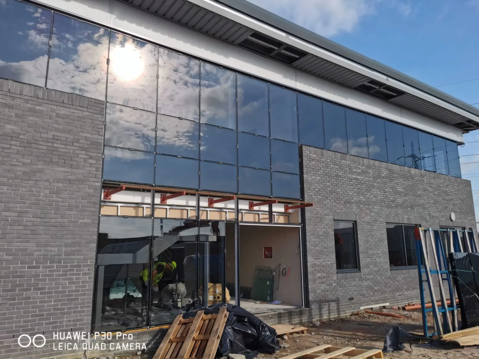 Glazing installation in progress at an office entrance.