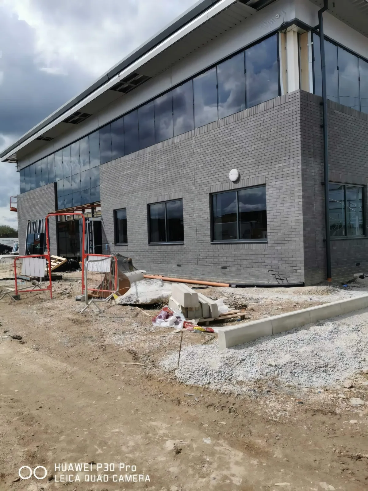 The corner of the office block, with the entrance glazing still in progress.