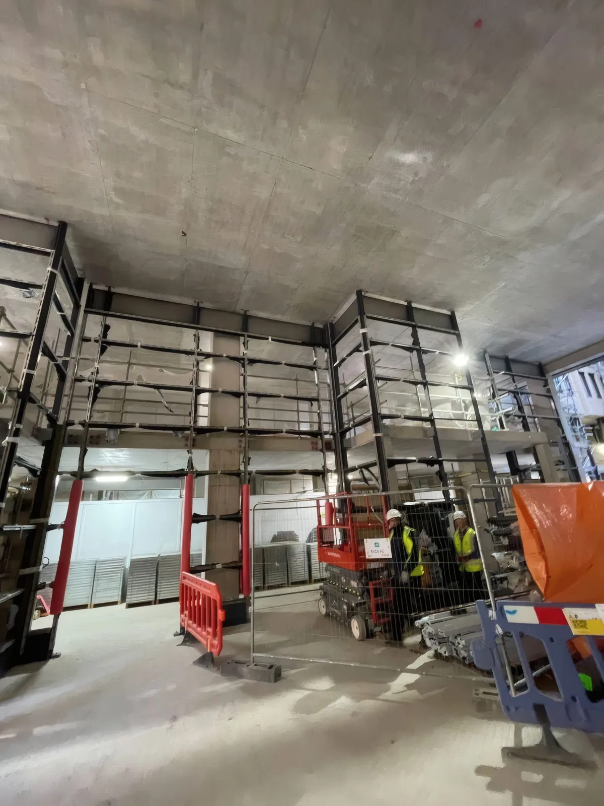 The OMFC International site team at the steelwork stage, with access plant positioned for the next lift.