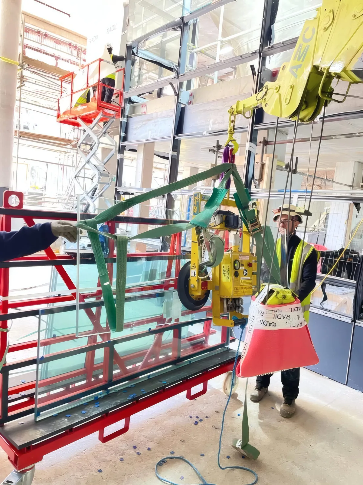 A glazing unit secured to the vacuum lifter at ground level, ready for the lift.