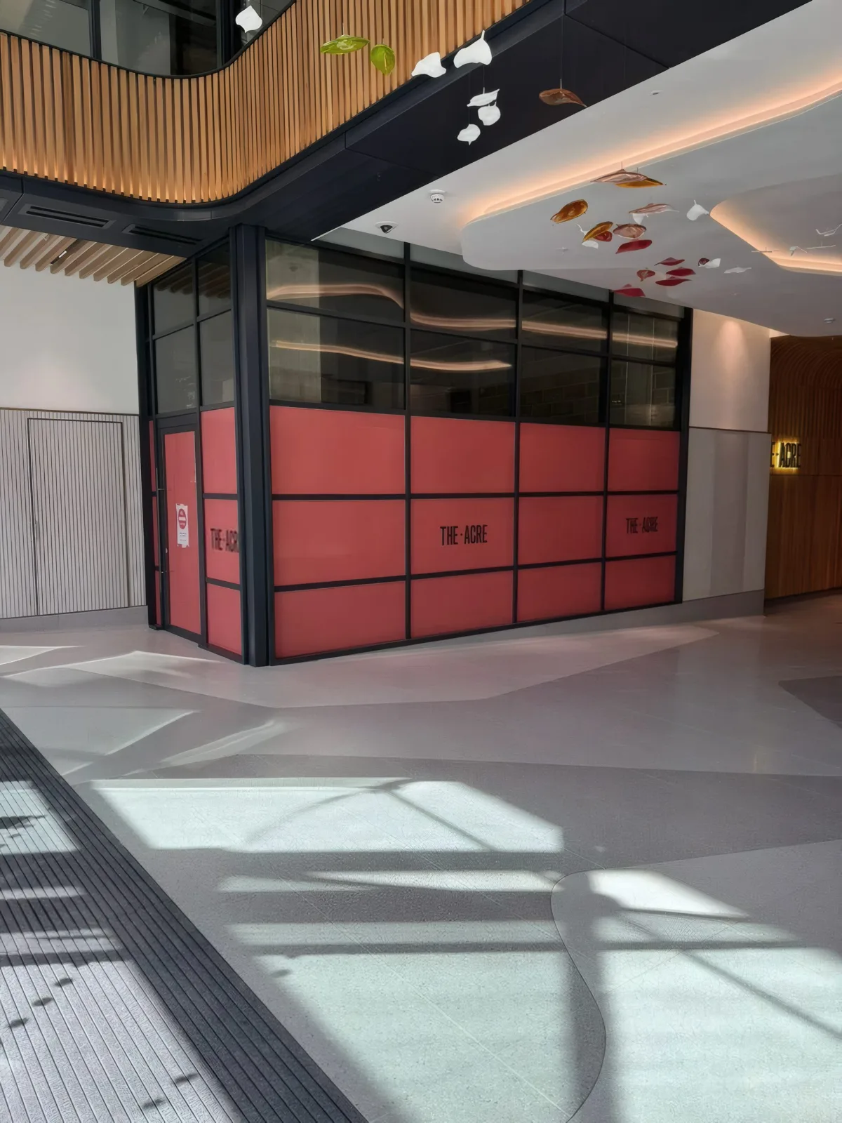 Completed glazed door set to the amenity area, with feature ceiling art installation above.