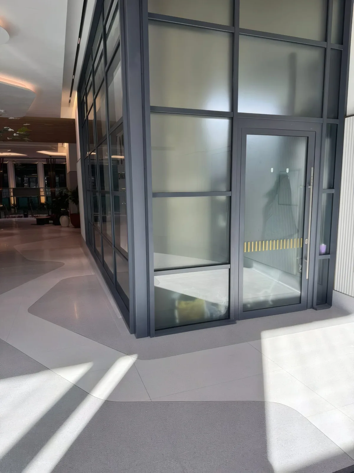 Completed glazed entrance vestibule in daylight.