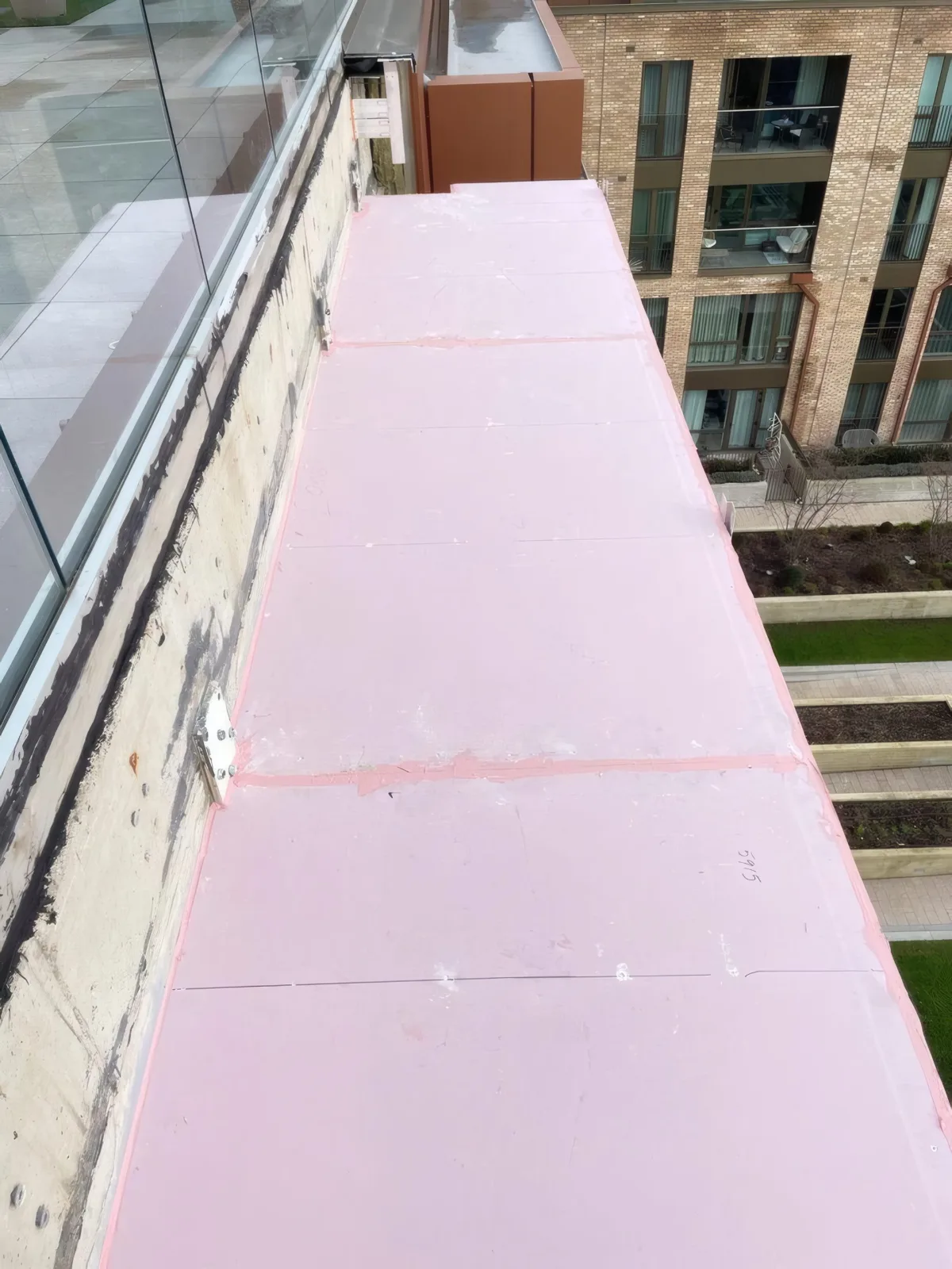Waterproof insulation panel detailing installed to a balcony parapet upstand.