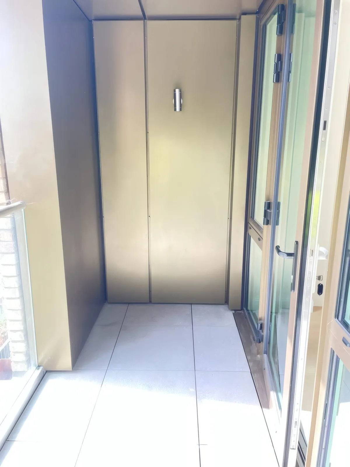 Completed balcony interior corner, with bronze-finish cladding soffit and canopy.