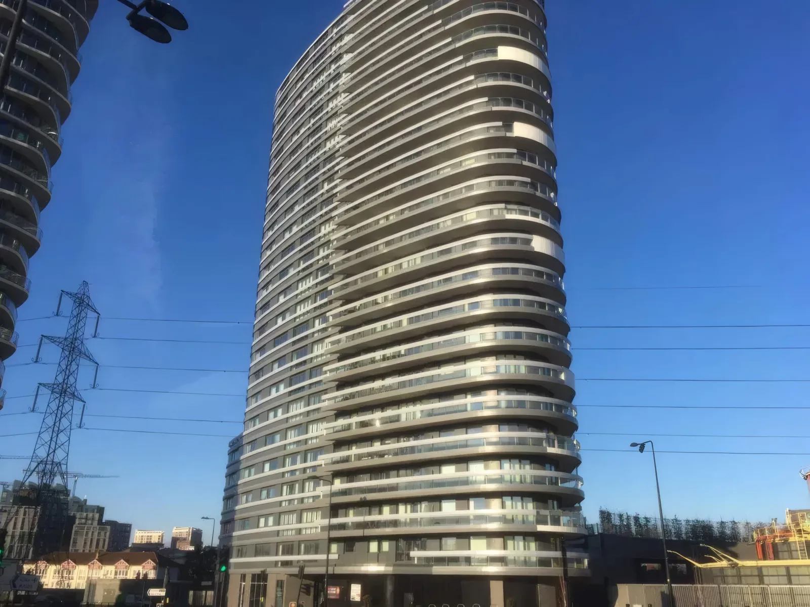 The curved balcony bands of the tower, seen from the street.